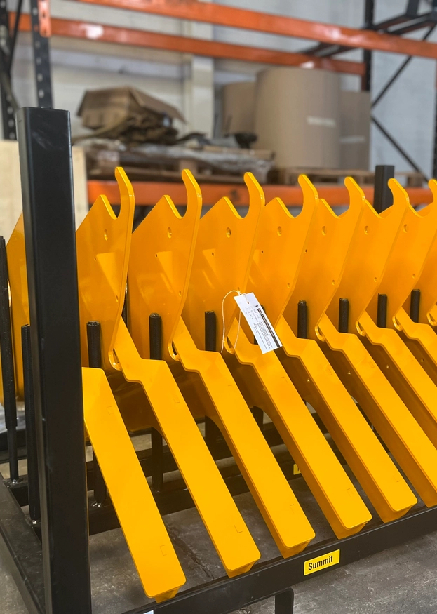 A rack of finished, painted, yellow goods waiting to be delivered.