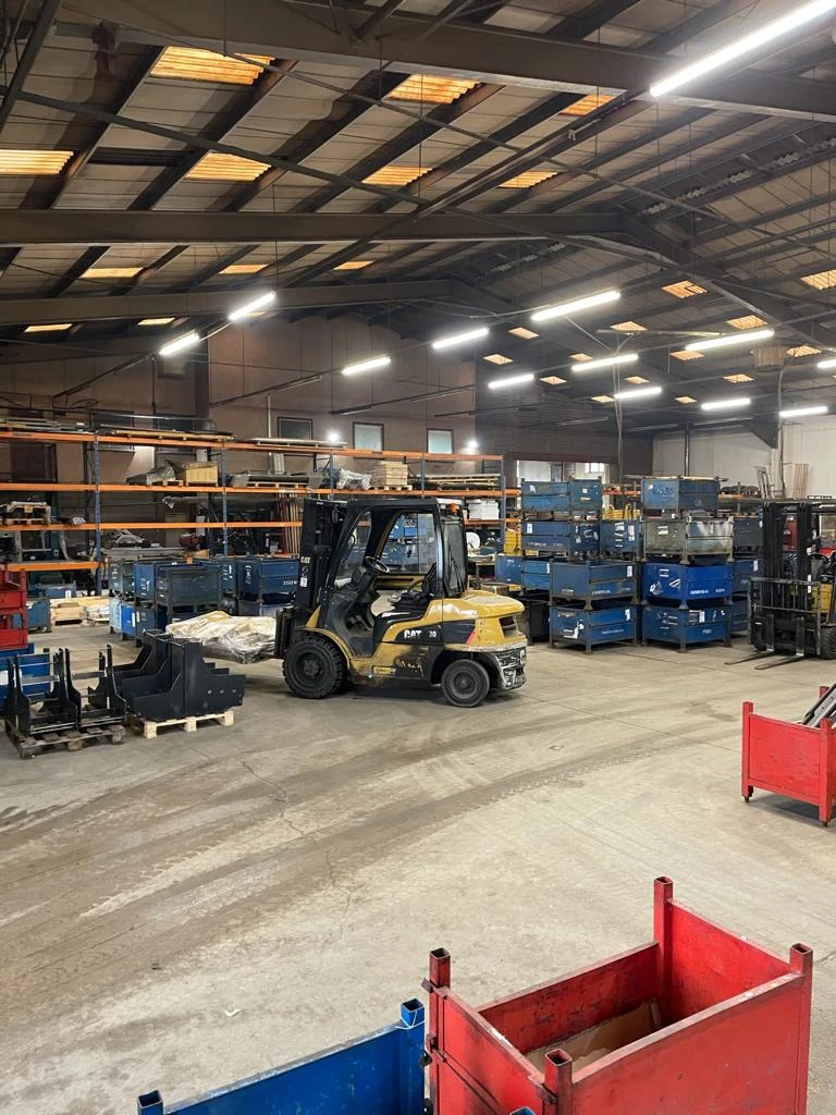 A forklift in the middle of the Summit Engineering warehouse