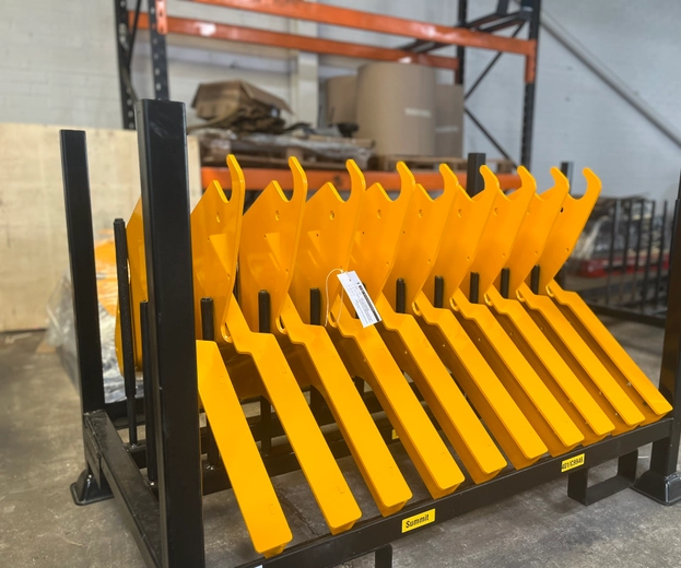 A rack of finished, painted, yellow goods waiting to be delivered.