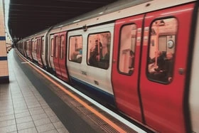 A london underground subway train waiting at a station