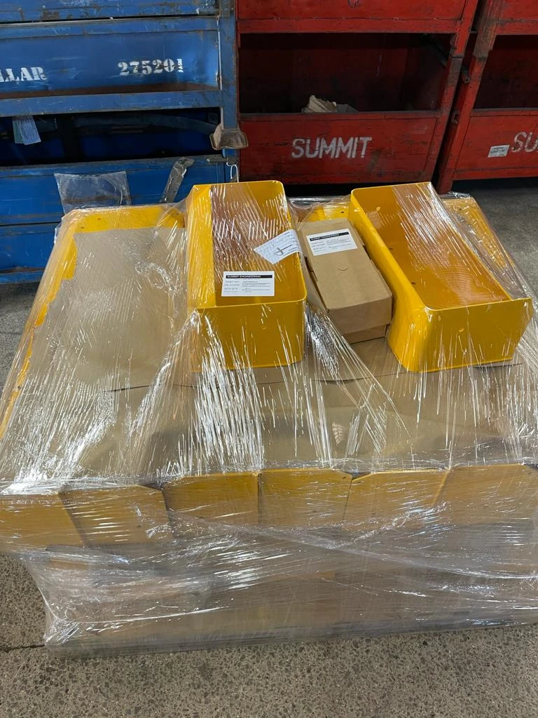 Finished assembled yellow goods, plastic wrapped and loaded on to pallets ready for delivery